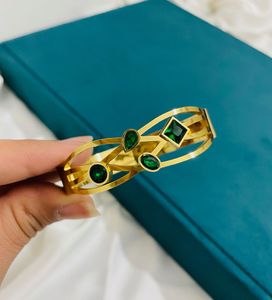 GOLD PLATED BANGLE WITH GREEN STONES