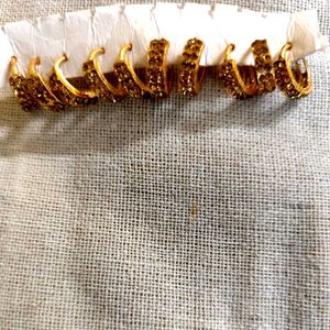 Set of 5 pair golden stone stdded huggie hoops.