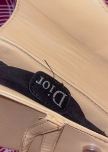 cute dior yellow bag with sling belt.