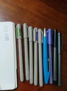 Assorted Pens and Notebook