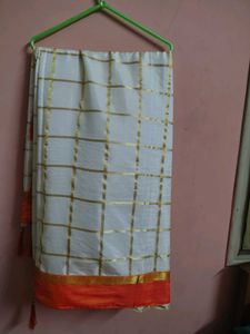 Cream saree with orange blouse