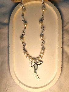 Elegant Pearl Necklace with Bow Charm