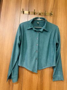 This is a teal-green pleated long-sleeve collared