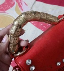 Chic Red Handbag with Gold Accent Handle