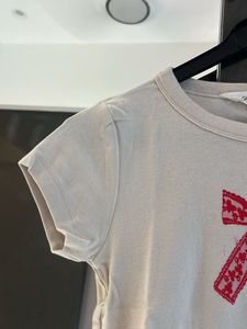 Cream T-Shirt with Red Bow Design