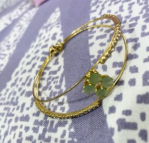 Elegant Gold-Tone Bangle with Gemstones
