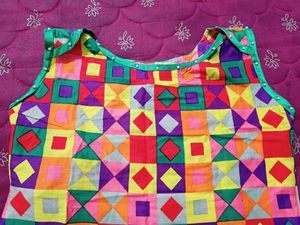 Multi Coloured Cotton Kurti With Pearls Attached On The Neck And Bottom Part.