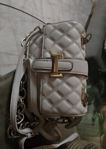 Beige sling bag along with chain slin