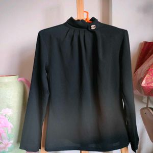 Elegant Black Mock Neck Top with Brooch