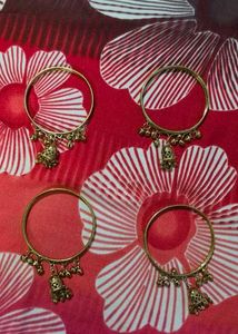 Set of 4 Gold Tone Bangles with Charms