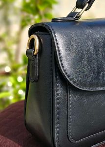 Chic Black Handbag with Gold Embellishment