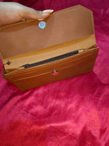 Chic Tan Clutch with Pom-Pom
