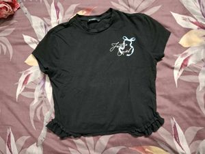 Black "Just a Girl" Cropped Tee with Ruffle Hem
