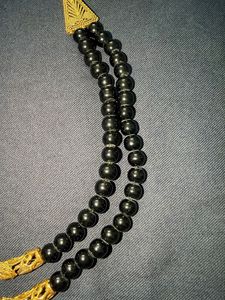 Black beads and golden finish costume jewellery