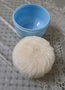Baby powder puff with a refill container