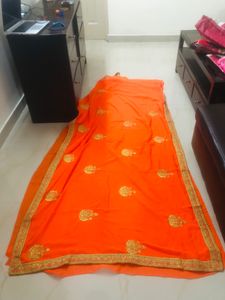 beautiful golden embroidery border orange saree