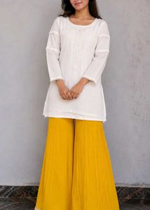 mustard colour plazo and off white top