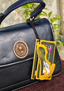 Chic Black Handbag with Gold Embellishment