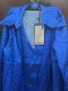 Vibrant Blue Button-Up Blouse with Geometric Patte