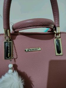Stylish Pink Textured Handbag with Charm