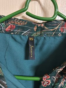 A green color floral print peplum top