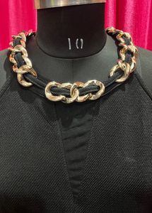 Chic Black Peplum Top with Chain Detail