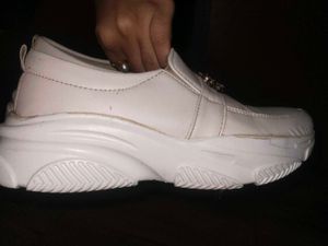 White slip-on shoes with embellishments