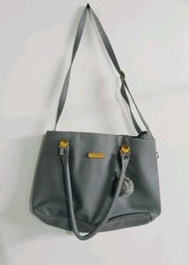 Stylish Grey Tote Bag with Pom-Pom Accent