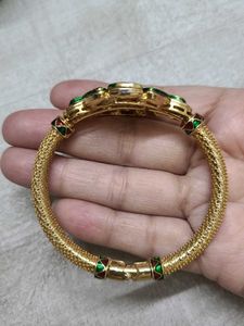 Elegant Gold Bangle with Green Stones