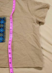 mustard-colored, short-sleeved top