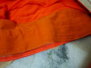 Vibrant Orange Saree with Pearl Embellishments