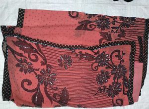 Elegant Coral Saree with Black Floral Print