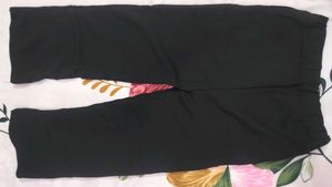 Aura Black Wide-Leg Pants with Gold Chain Detail
