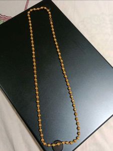 Elegant Gold Beaded Necklace with Swastik