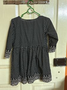 A Black with Beige polka dots top