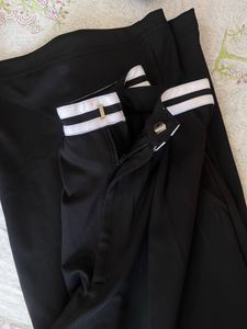 Black trousers with white stripe detail