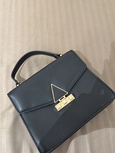 Chic Black Handbag with Gold Accent