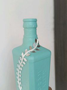 Decorative Teal Bottle with Vine Accent