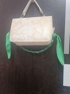 Chic Cream Textured Handbag with Green Scarf Accen