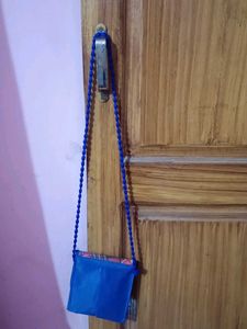 Blue purse with barbie in front