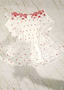 White top with red embroidery
