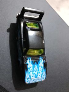 Black hotwheels Car with blue Flames