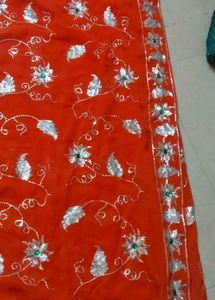 Elegant Orange Saree with Silver Embellishments
