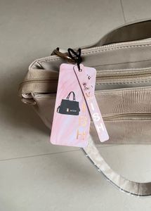 Stylish Beige Textured Handbag with Butterfly Char