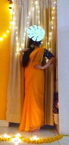 Simple Saffron colour chiffon saree with fine gold border