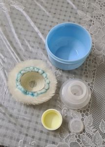 Baby powder puff with a refill container