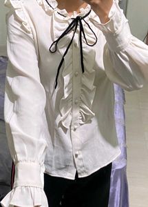 Ruffled White Blouse with Black Bow