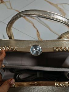 Elegant Gold Clutch with Gemstone Accent