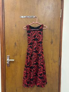 Black lacy dress with red floral detailing