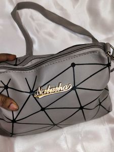 Grey geometric sling bag
